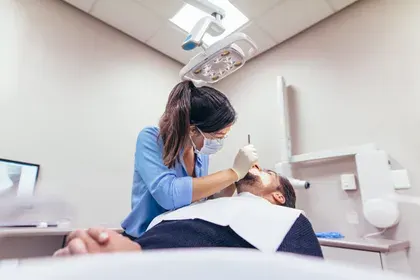 Man in Dentist Chair Undergoing Procedure