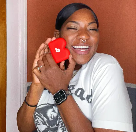 Woman smiling holding dring and byte aligner box