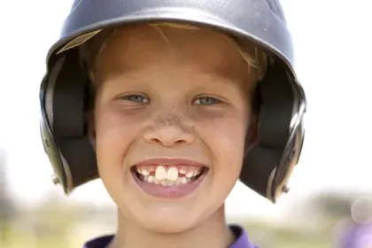 Boy in Baseball Helmet Smiling