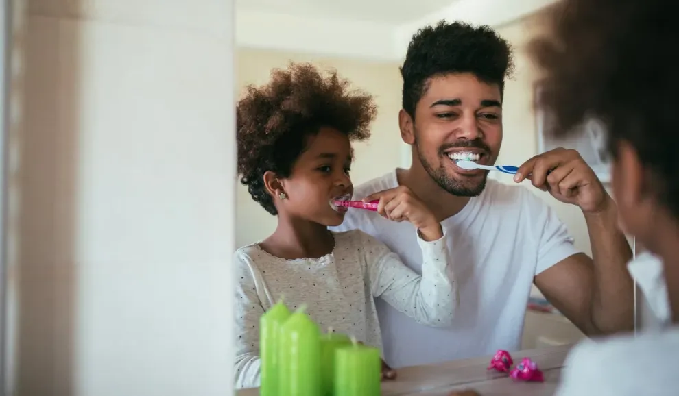 Father and Daughter Brushing Teeth