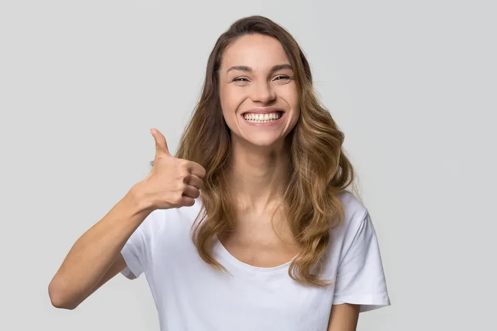 young-woman-smiling-thumbs-up