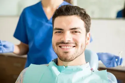 Man Smiling at Dentist Office