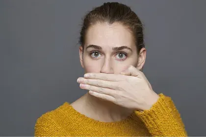 Woman Covering Mouth