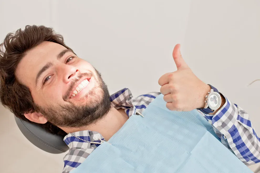 man-in-dental-chair-thumbs-up