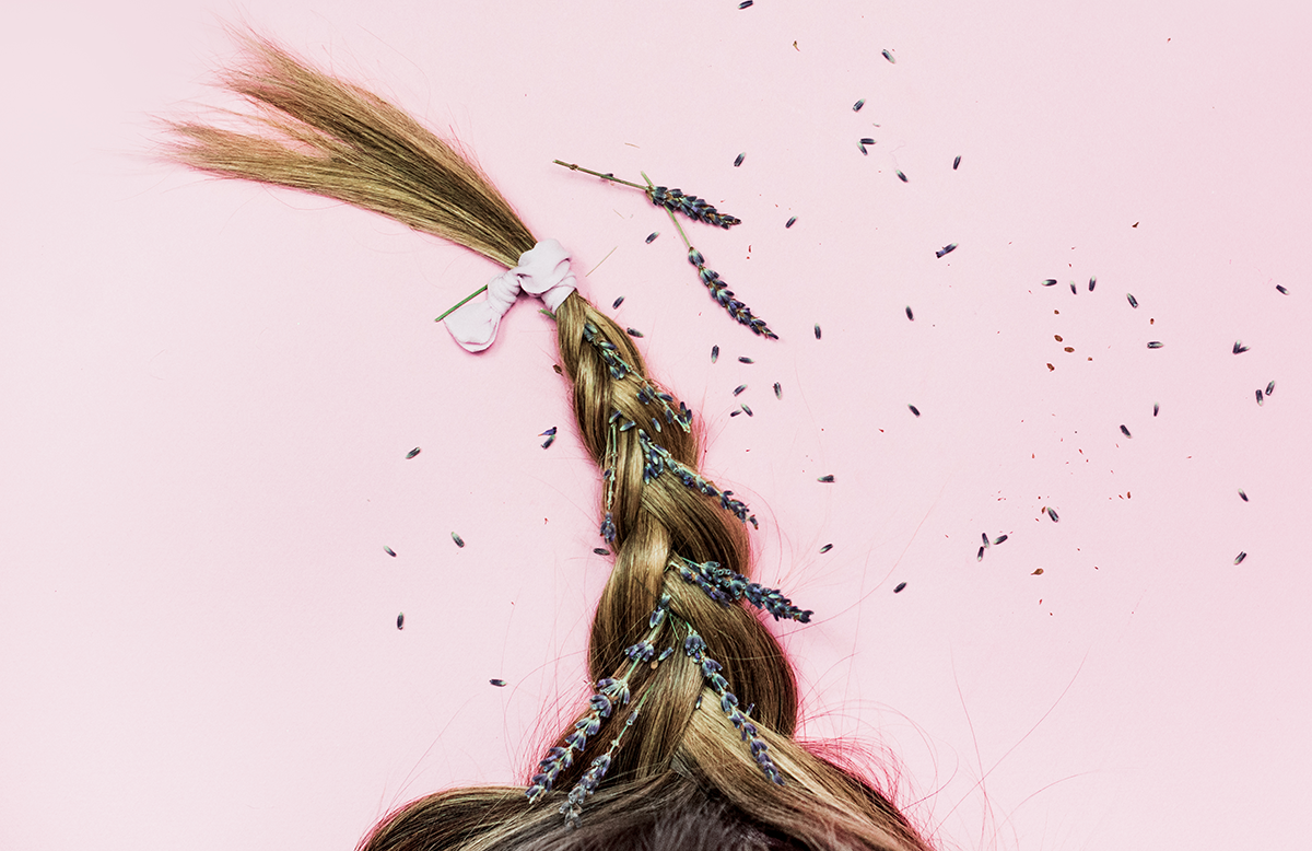 Lavender buds in braided brunette hair