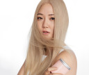 Woman with smooth, soft and healthy-looking straight hair holding her Custom Hair Mask. 