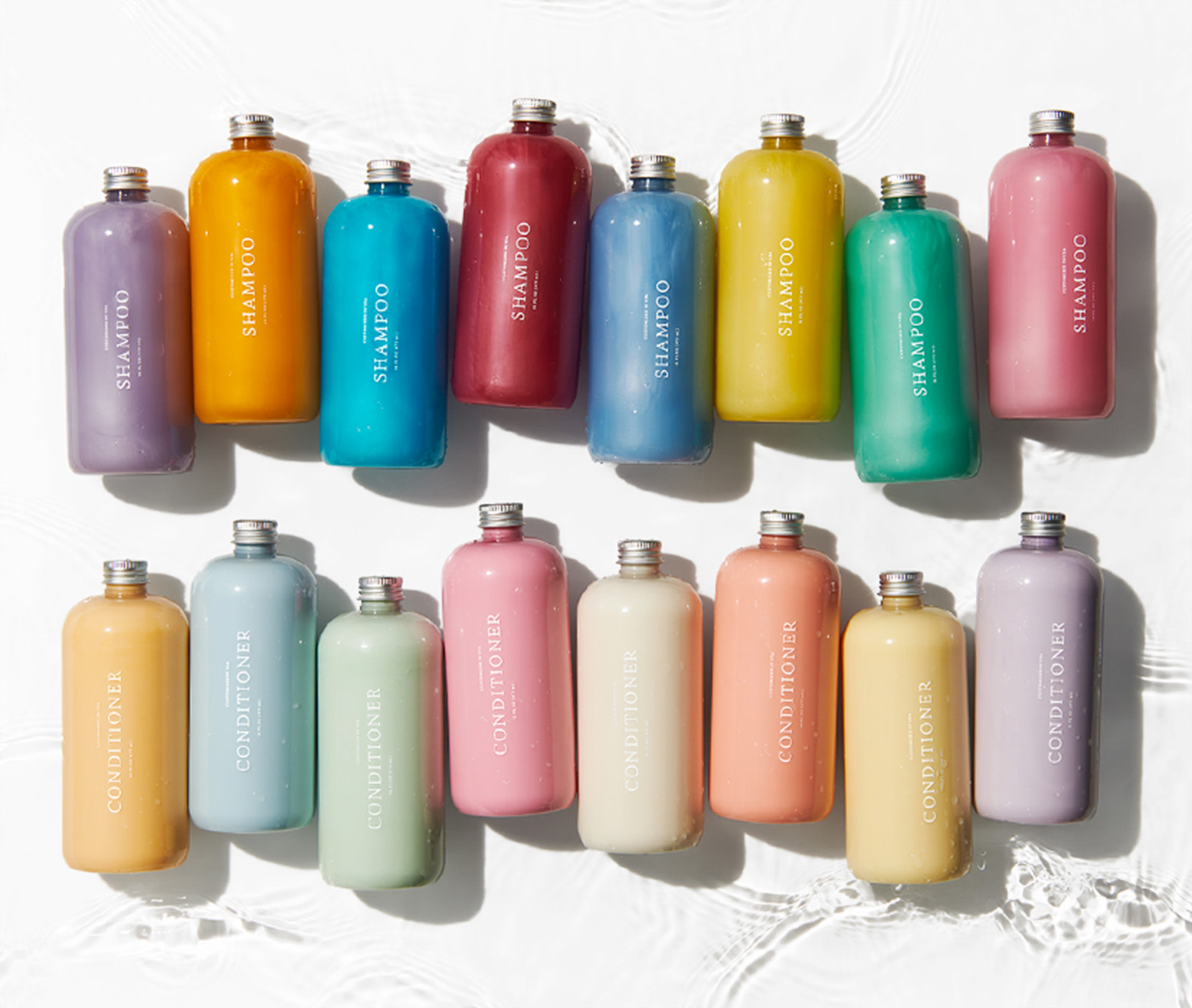 Customized shampoo bottles lined up in every color in horizontal row. Customized conditioner bottles lined up in every color below shampoos in horizontal row.