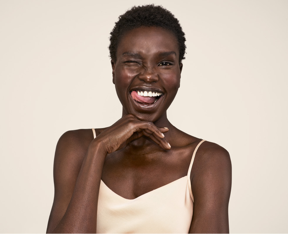 woman winking and showing glowing skin from aveeno