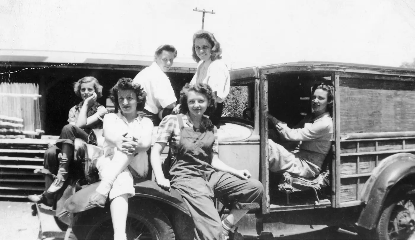 Black and white image of women in work wear on a truck