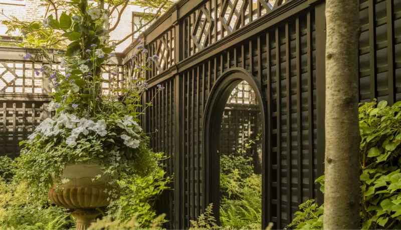 Detailed brown lattice fence with archway