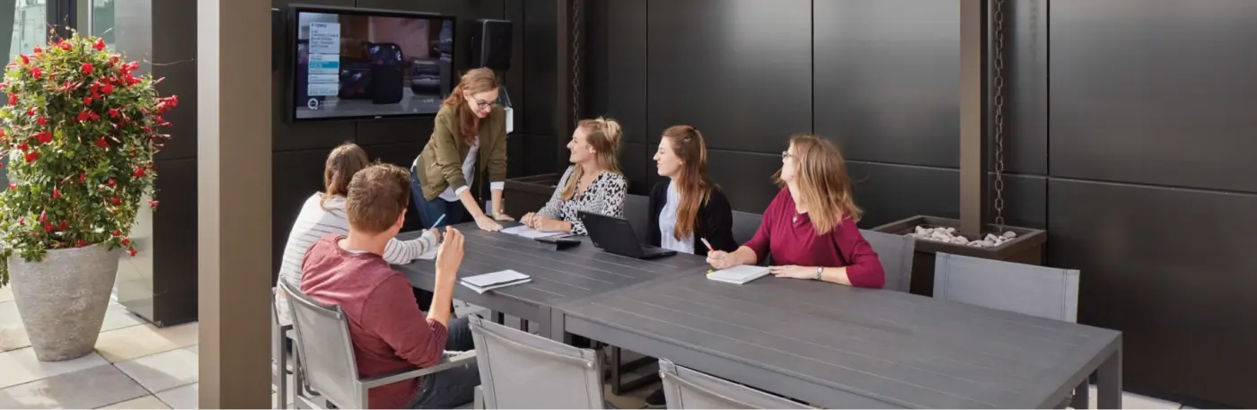 employees sitting at a conference table in a meeting