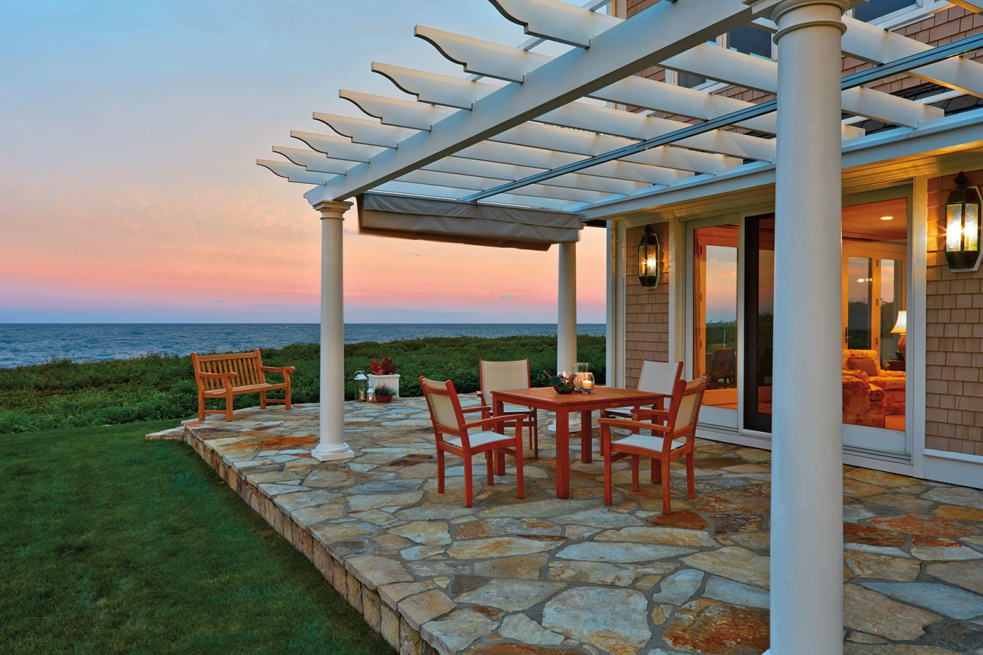 Attached white pergola with seating area on ocean