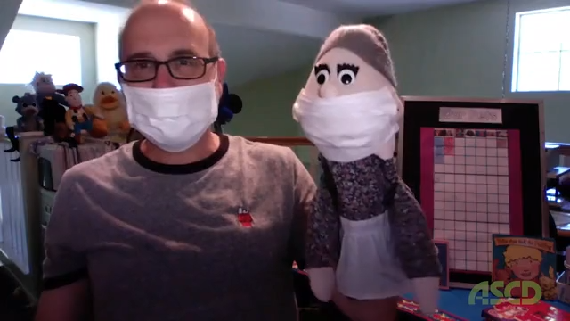 An instructor with a puppet taken as a still from the video