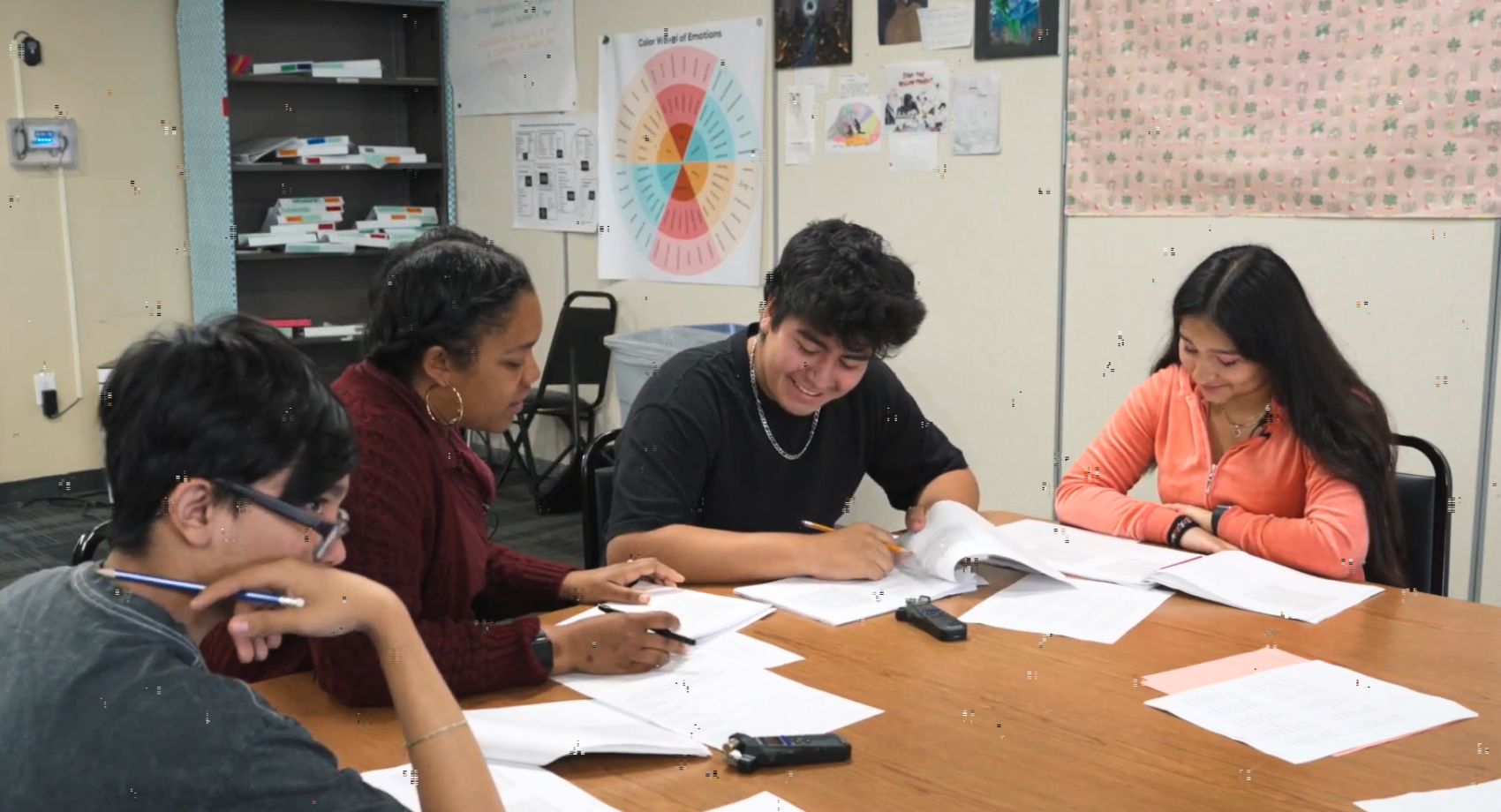 Still from a classroom video showing a teacher using differentiated instruction to work one-on-one with a student on a reading literacy task.