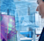 A professional woman in profile with a blue digital overlay of a colorful 3D Trimble BIM model and architectural design software interface.