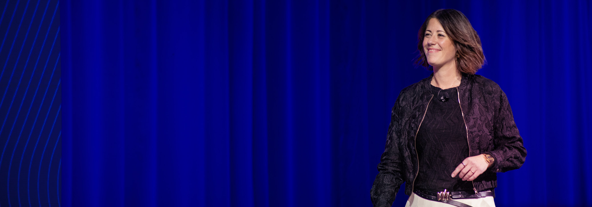 A Dimensions speaker smiles and addresses the crowd during his session.