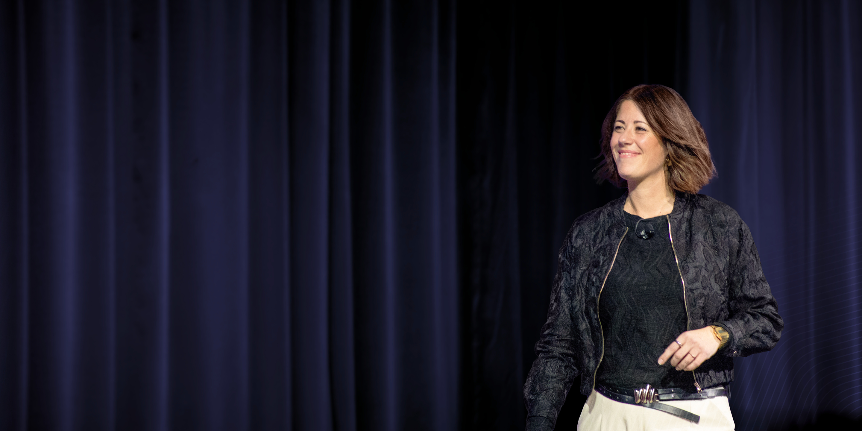 A Dimensions speaker smiles and addresses the crowd during his session.