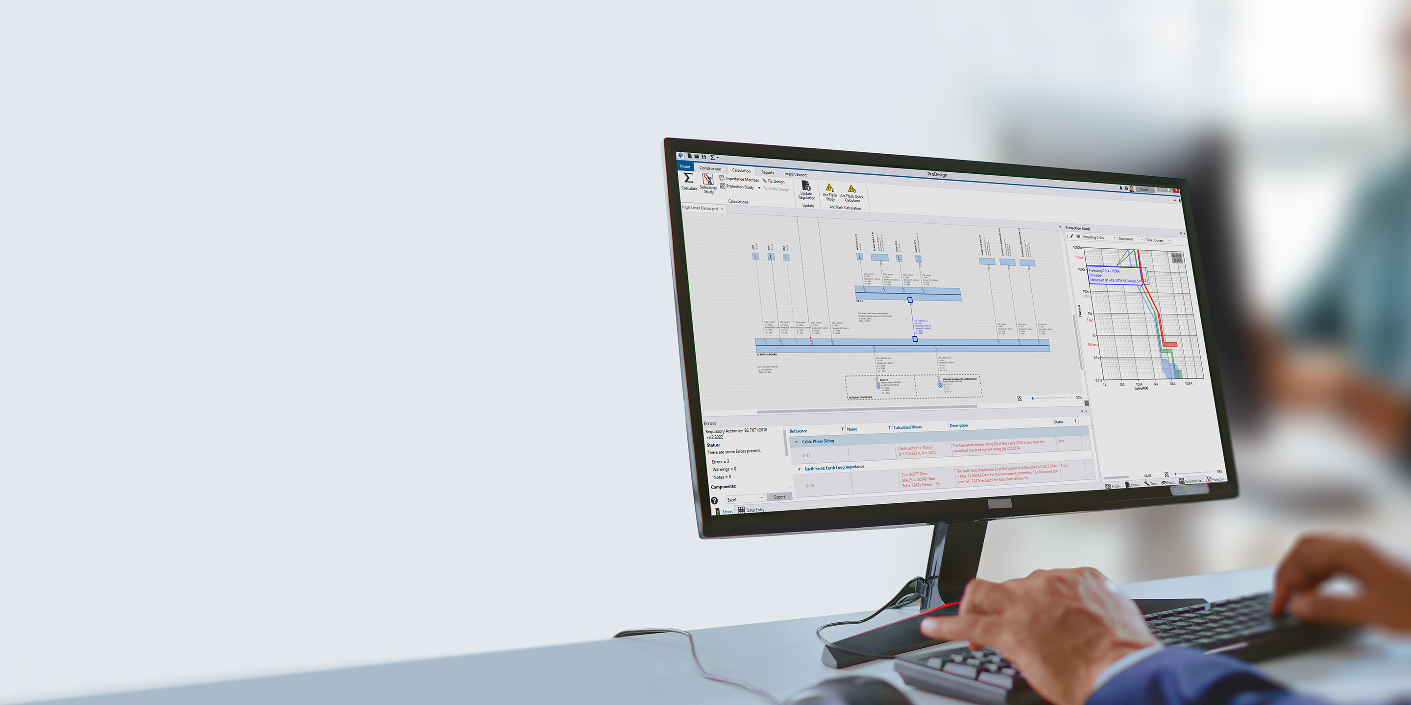 Close-up of a person using Trimble Electrical Designer software on a monitor to create electrical schematics