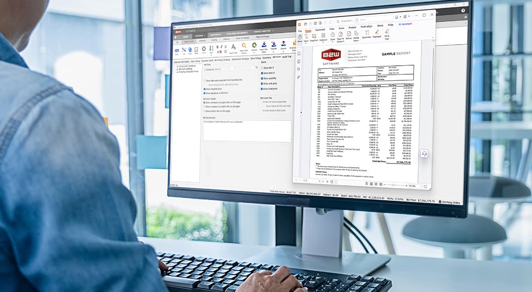 A professional uses Trimble’s B2W Estimate software on a computer monitor to review construction bidding and report data.