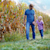 Father and daughter holding hands looking at each other smiling on farm