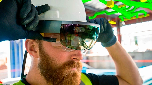 Man putting on Trimble HoloLens with building pipes highlighted in background