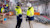 Image alt text: Two men in hardhats and protective gear, discussing construction progress on the inside of a building.
