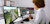 Woman on multiple computer screens using Trimble software to help plan and design new roadway