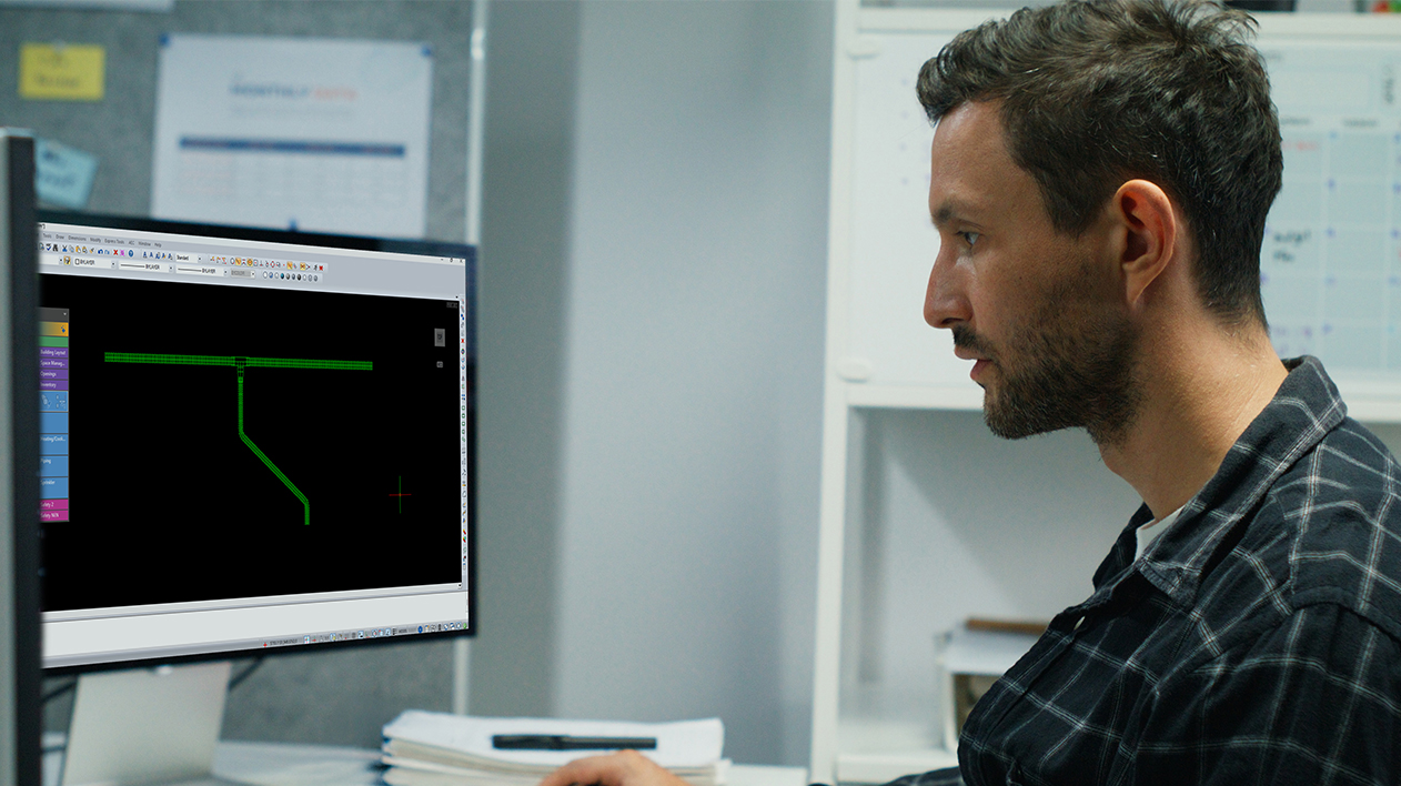 Man looking at a monitor displaying the Stabicad for IntelliCAD interface.
