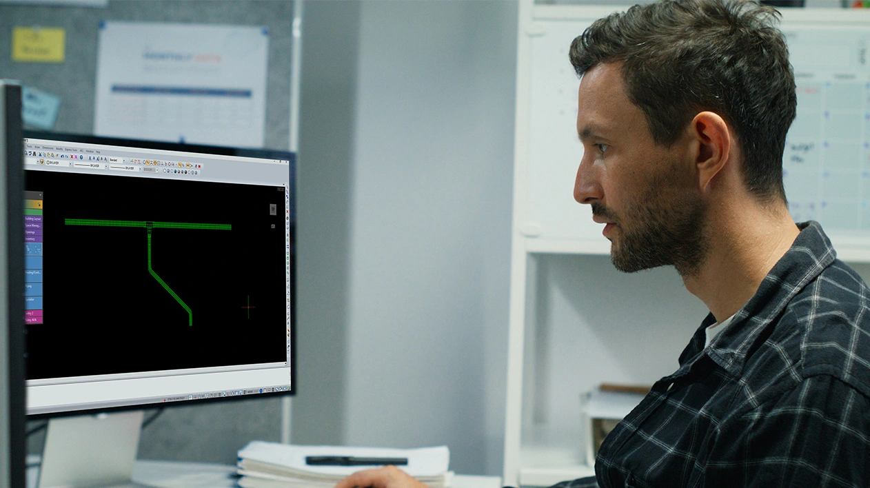 Man looking at a monitor displaying the Stabicad for IntelliCAD interface.