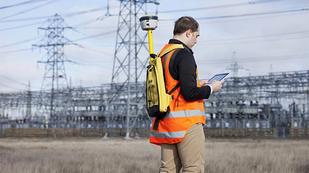 Engineer using Trimble geospatial technology to capture a digital twin of the electric network