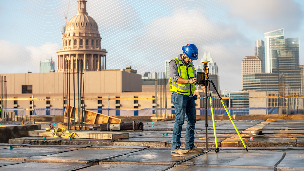 JE Dunn team member verifying a layout point with precision tools during a concrete pour in Austin, Texas.