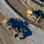 An aerial, top-down view of two yellow construction vehicles, a bulldozer and a grader, positioned on a dirt and gravel worksite