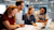 Group of young, diverse business professionals smiling while looking at a laptop