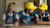 School children in West Bengal, India smiling while sitting at table