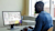 A person works at a computer, using Trimble Estimation Desktop digital takeoff and estimating software on the screen.