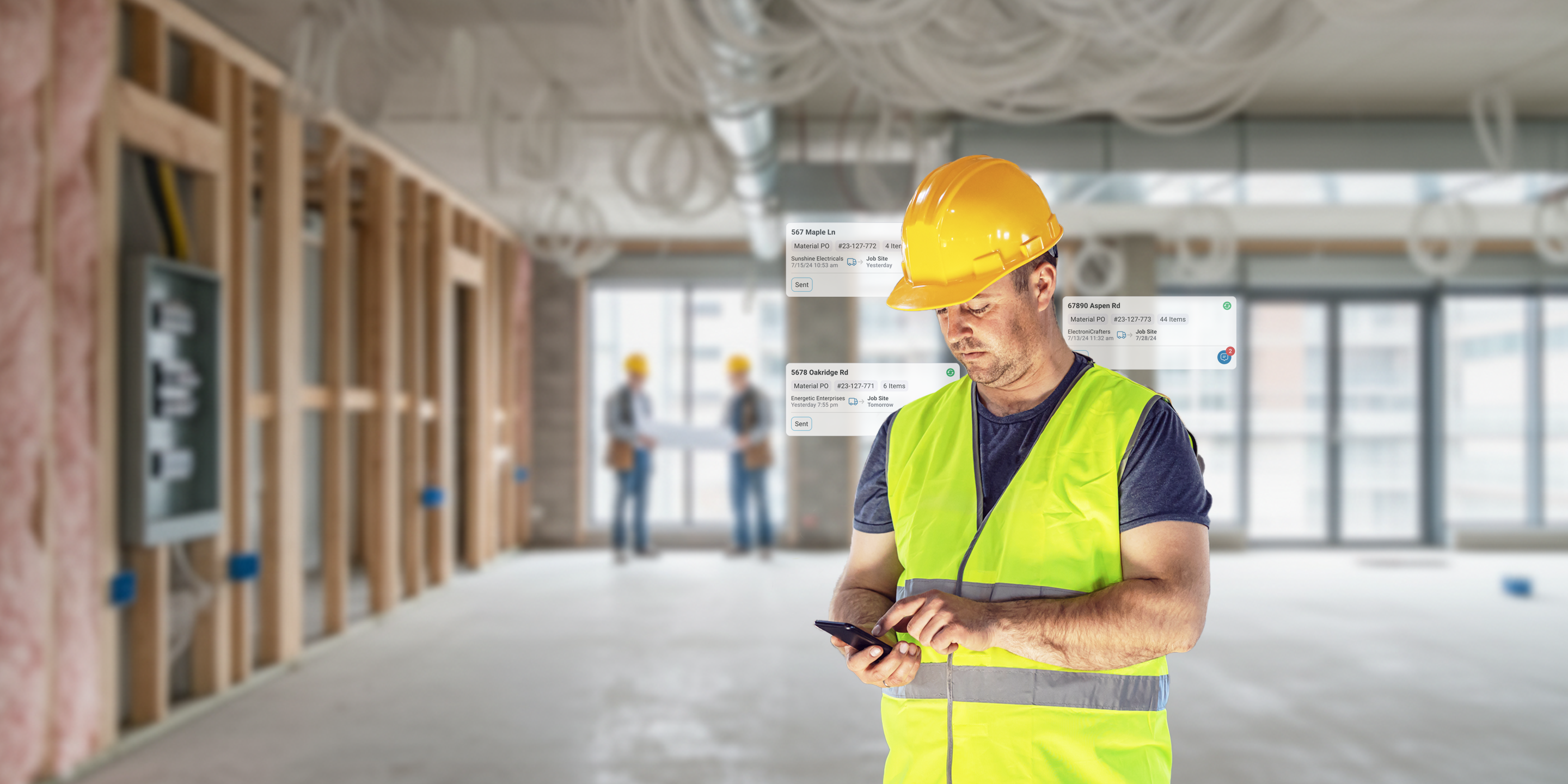 A person wearing a hard hat and safety vest on a jobsite using mobile construction procurement software