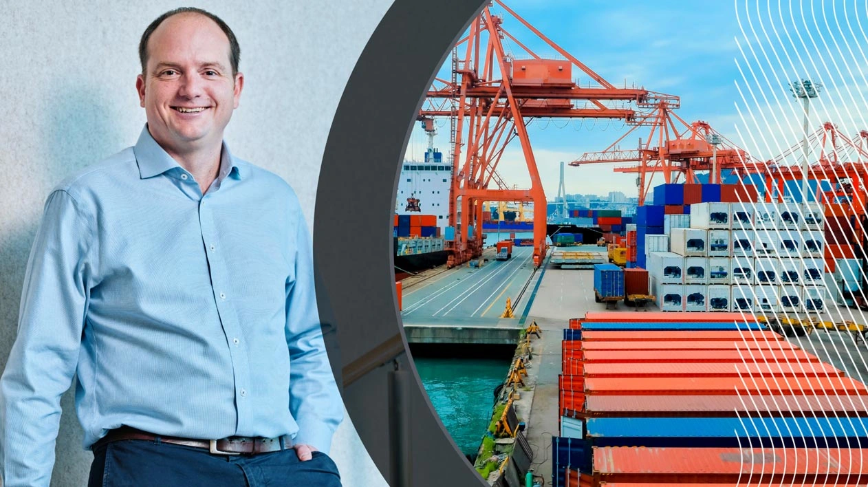 A smiling man in a blue shirt next to a circular graphic of a busy shipping port with cargo ships and cranes, showcasing Trimble logistics.
