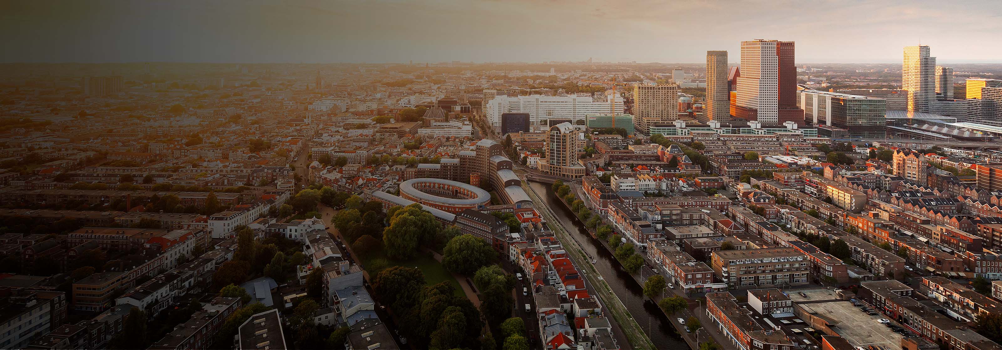 An aerial view of a sprawling cityscape with a mix of residential and modern buildings.