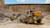 Heavy machinery moving rocks at job site