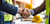 A construction worker shaking hands with a corporate executive on a jobsite