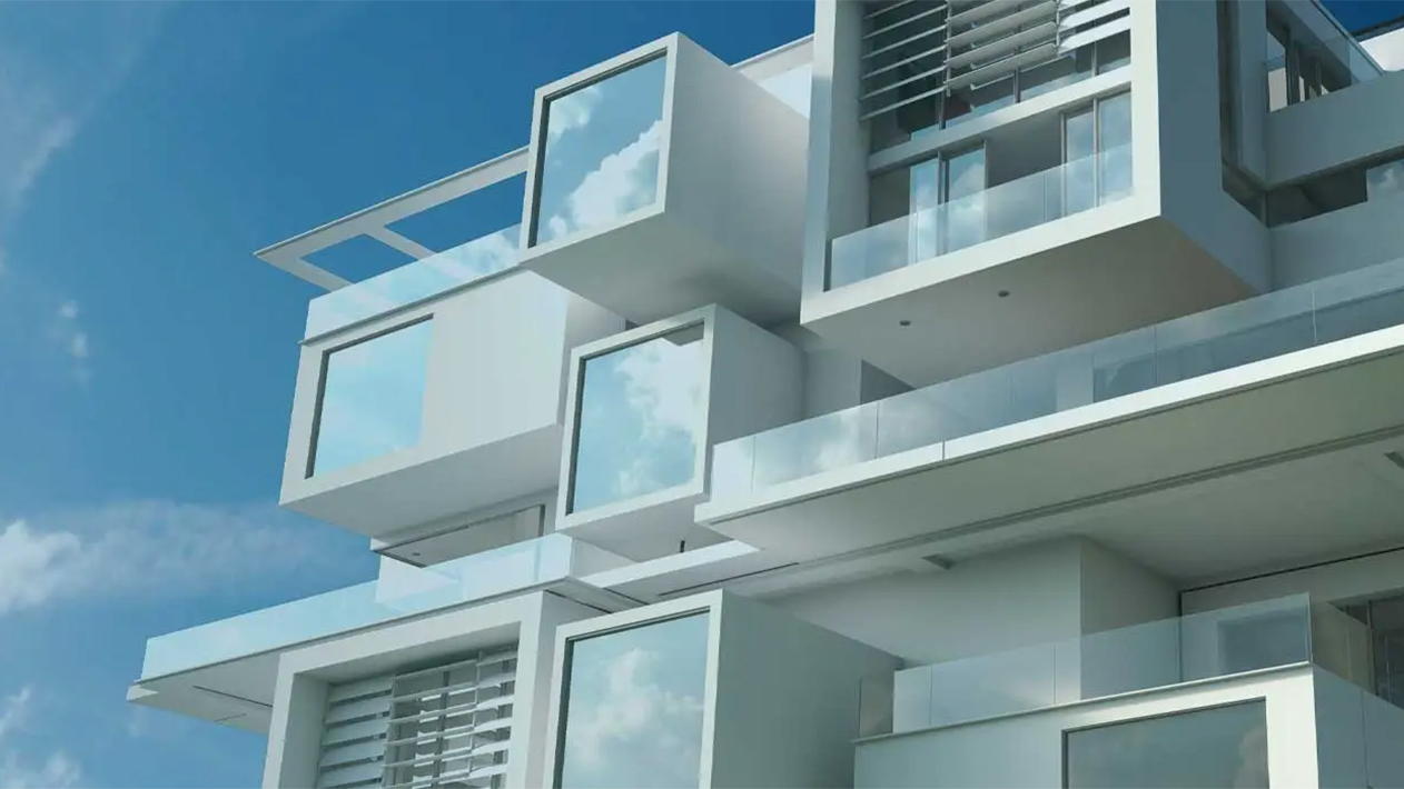 Upward view of modern, modular white building with blue sky
