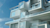 Upward view of modern, modular white building with blue sky
