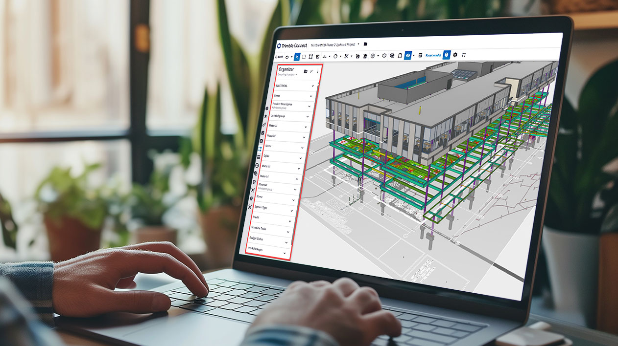 A person using Trimble Connect on a laptop to view a 3D building model, with the Organizer panel highlighted in red.