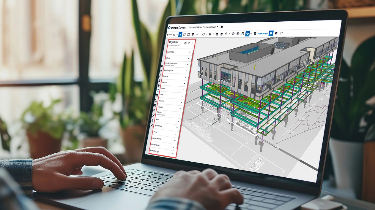 A person using Trimble Connect on a laptop to view a 3D building model, with the Organizer panel highlighted in red.