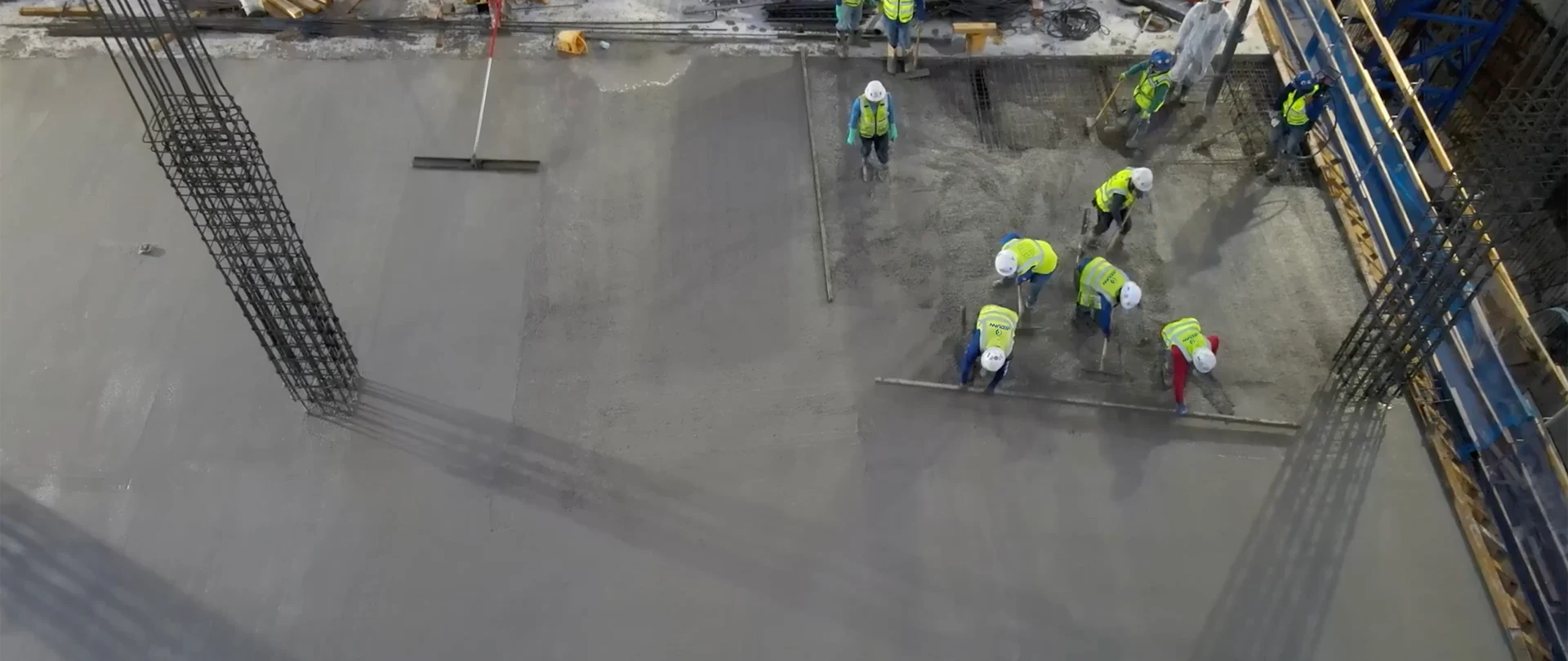 JE Dunn construction team reviewing a digital model on-site, discussing layout and coordination.