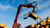 Upward view of heavy machinery lifting piles of wood