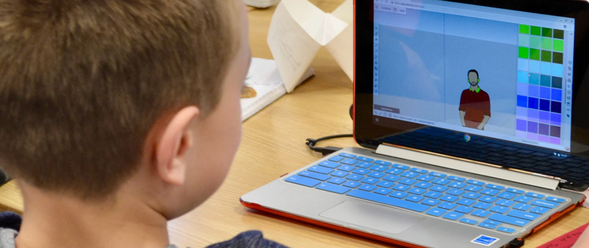 Child using Trimble SketchUp on laptop in classroom