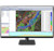A desktop monitor displays Trimble Quantm software