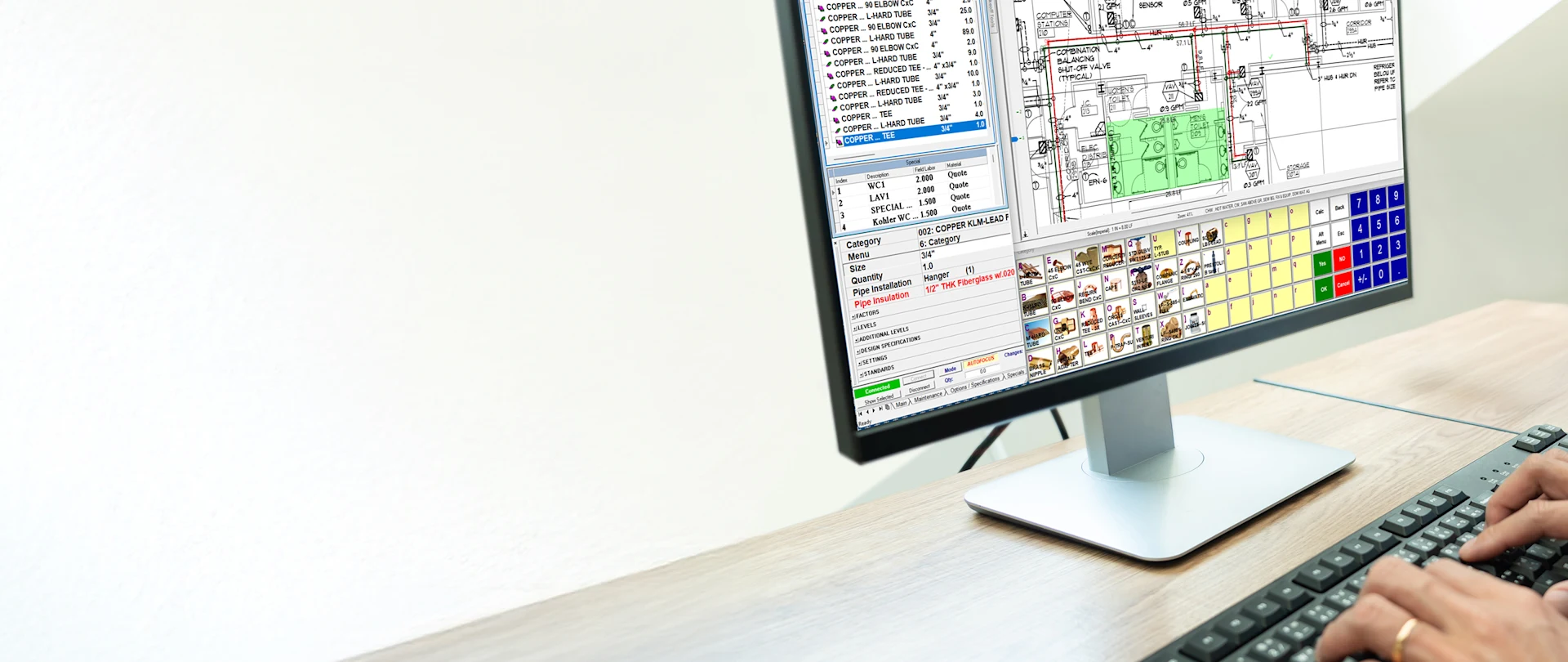 A person's hands are visible on a keyboard while a monitor displays Trimble Estimation Desktop software for MEP contractors.