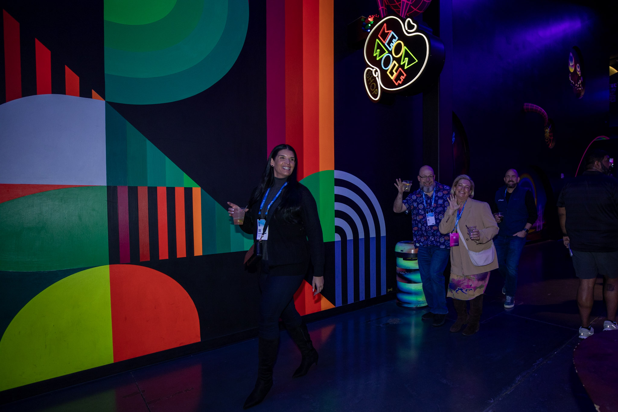 Trimble Dimensions attendees enter the Customer Appreciation Party at AREA15 while smiling and waving to the camera.